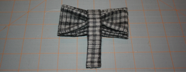 middle section of bow tie has been added, partially attached but covering pinched material.